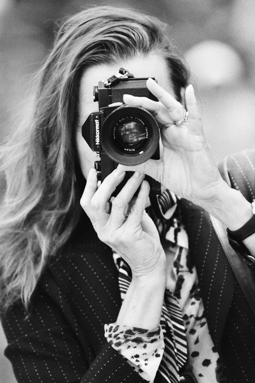 A photographer raising a film camera to her eye during the Amsterdam analogue workshop