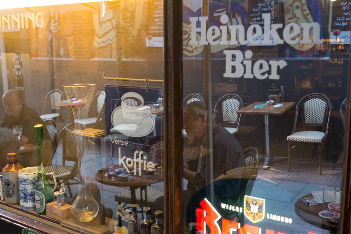 Reflection of an Amsterdam cafe window with Heineken and koffie signs