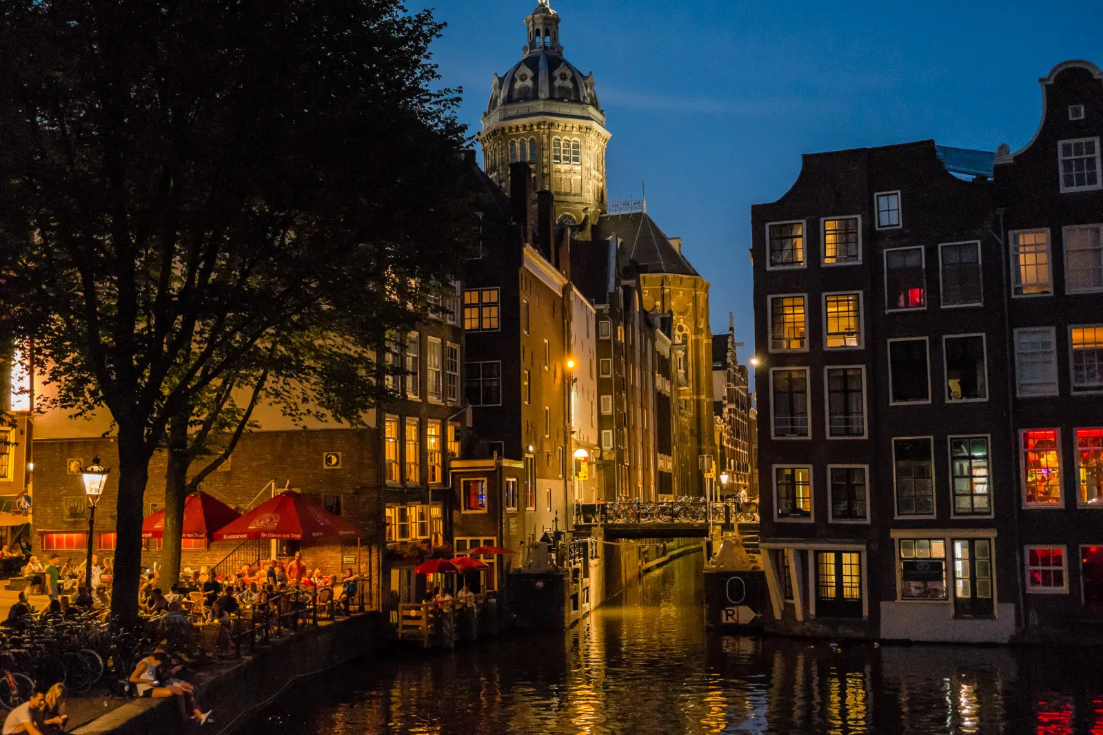 Amsterdam canal houses lit up at dusk