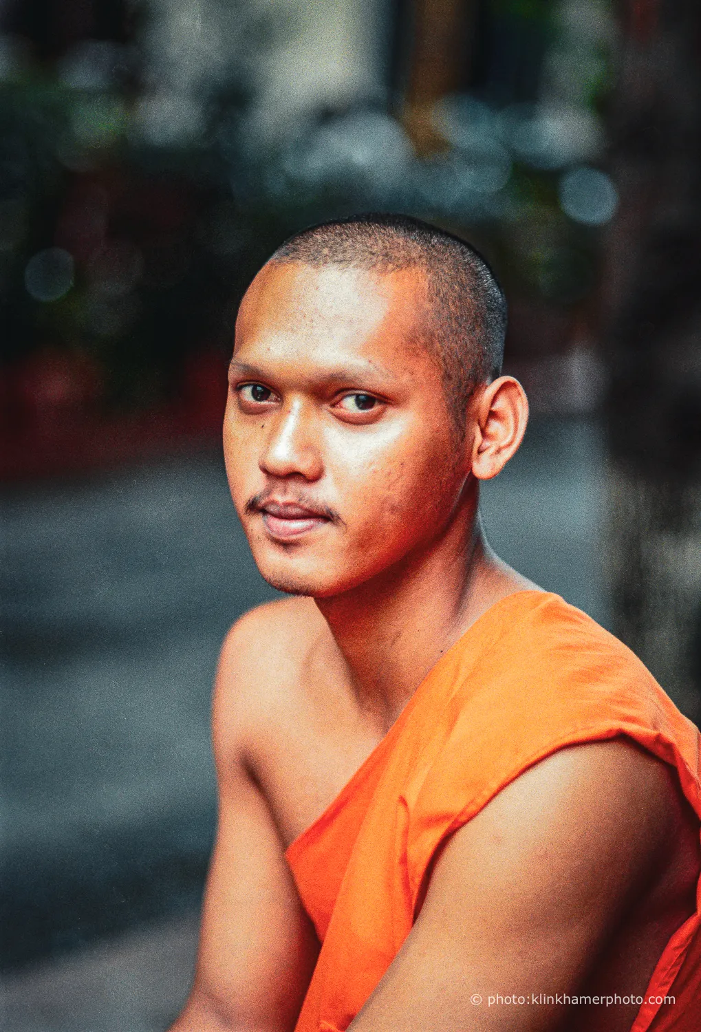 Young Buddhist monk in an orange robe, colour portrait