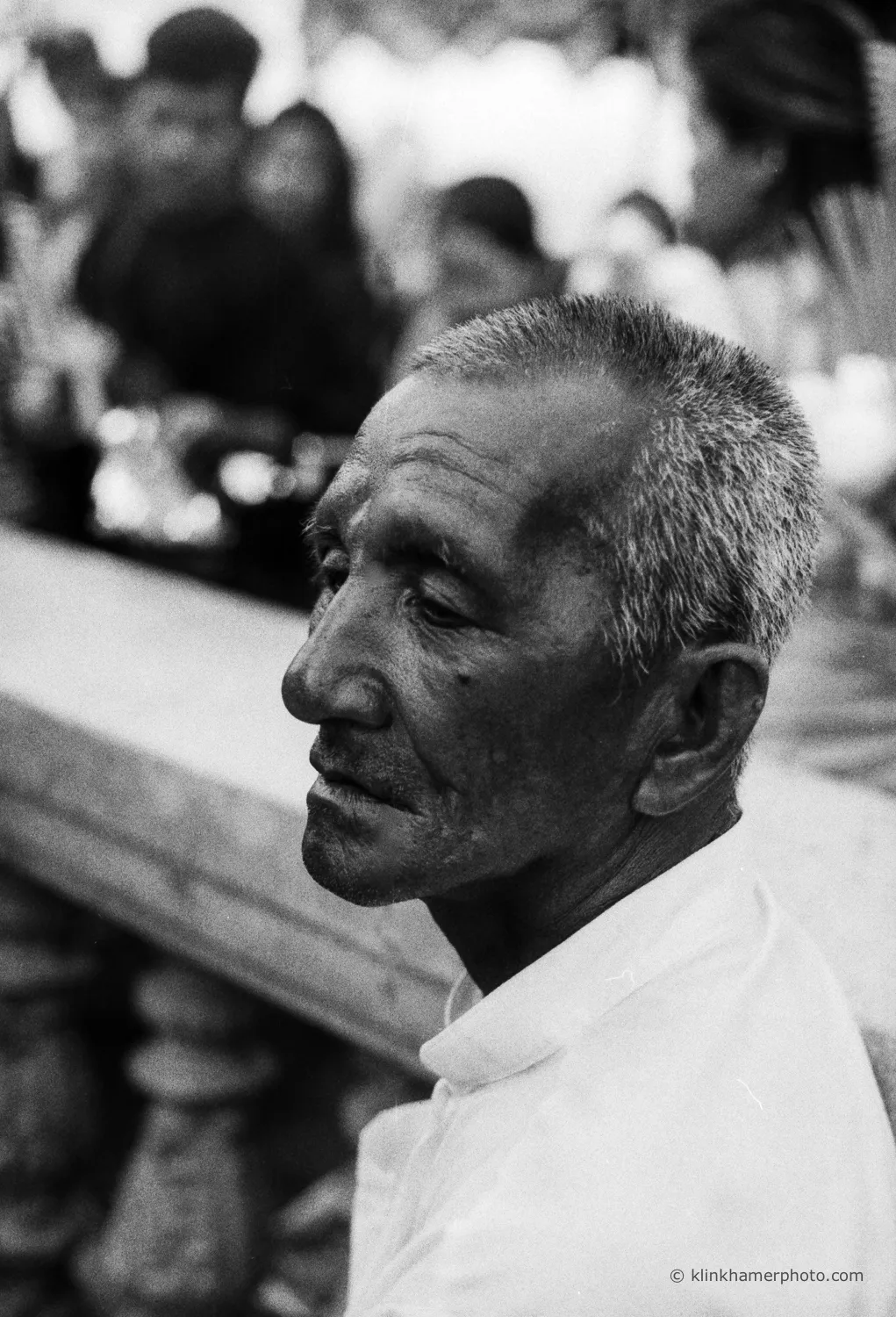 Black and white film portrait of an elderly Cambodian man