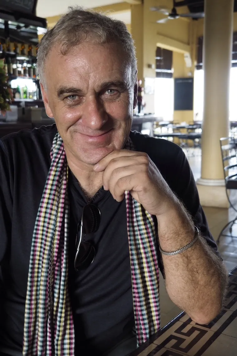 Michael Klinkhamer, smiling, wearing a Cambodian krama scarf
