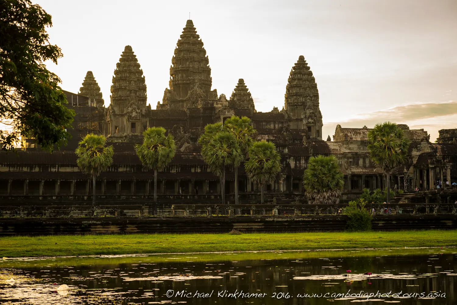 The towers of Angkor Wat at dusk, reflected in the moat