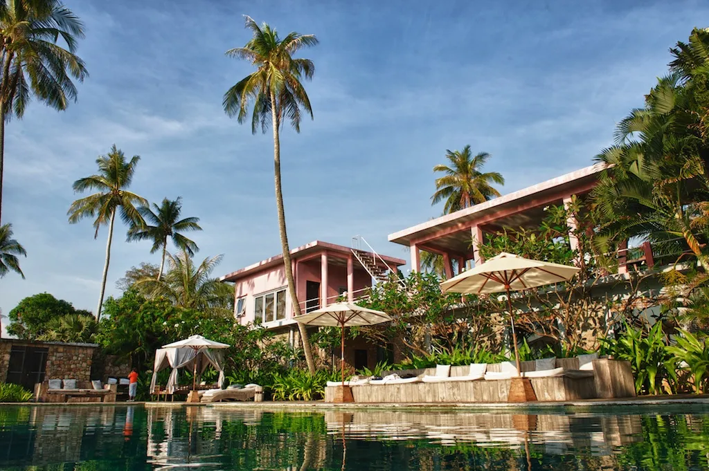 Palms and waterfront buildings on the southern coast of Cambodia at Kep