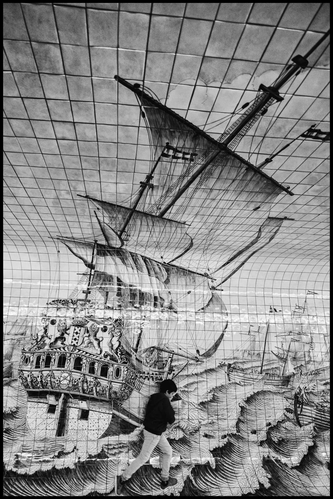 Black and white mural of a sailing ship on an Amsterdam wall